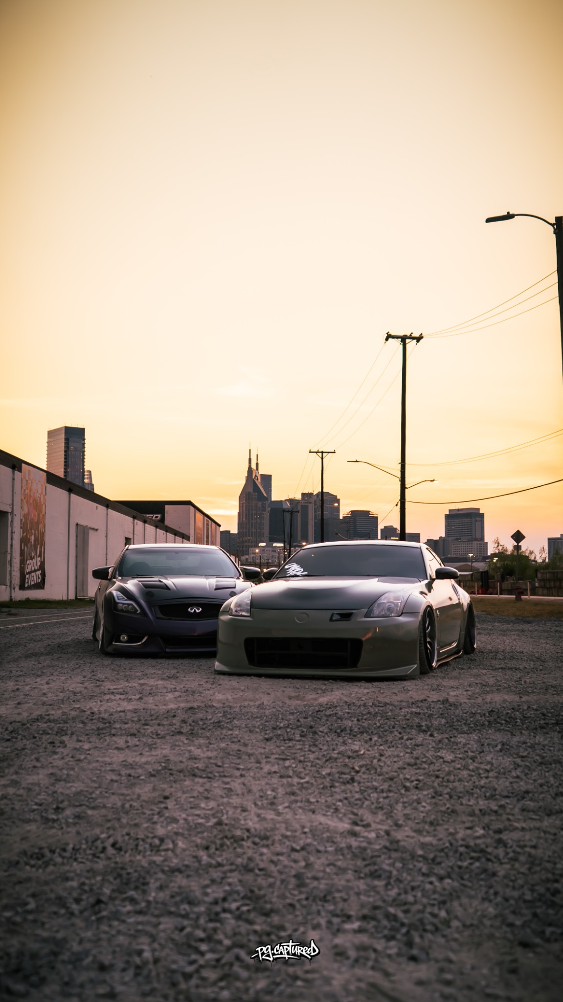 Purple Infiniti G37 and Nissan Z photographed against the Nashville skyline at sunset