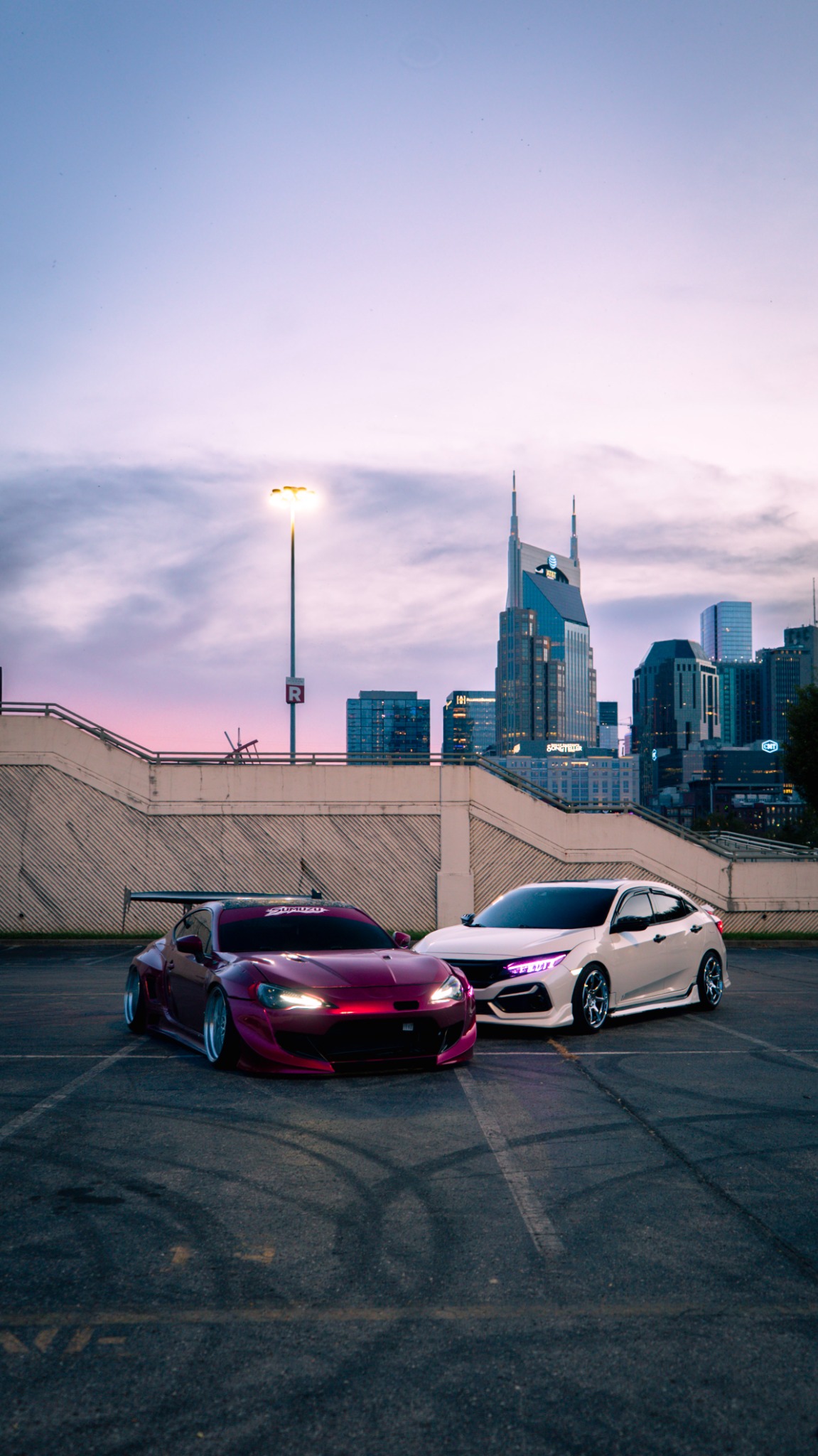 Two modified cars with the Nashville skyline